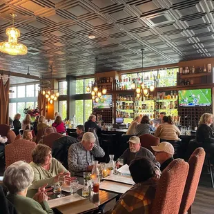 a large group of people sitting at tables in a restaurant