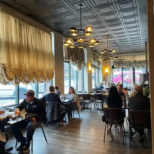 people sitting at tables in a restaurant