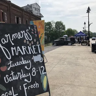 a blackboard sign on a sidewalk