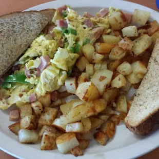 This is a Denver Scramble with green peppers and ham. Served with the best American fried potatoes and your choice of toast.