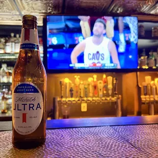 a bottle of ultra beer on a bar counter