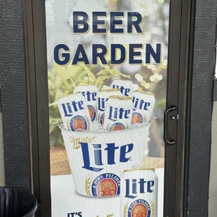 a beer garden sign on a door