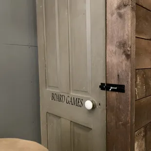 A door by the couches full of  board games!