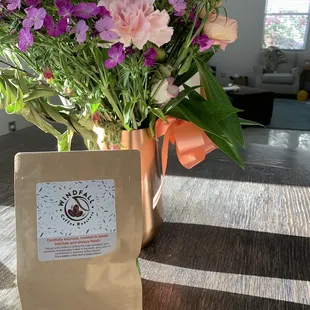 a bouquet of flowers in a copper vase