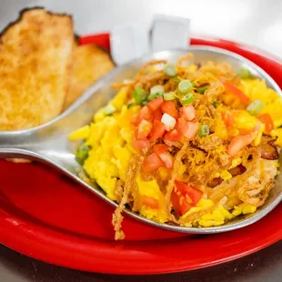 a red plate with a spoon on it