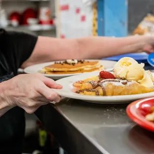a woman serving waffles