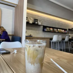 a glass of iced coffee on a wooden table