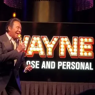 a man in a suit singing into a microphone