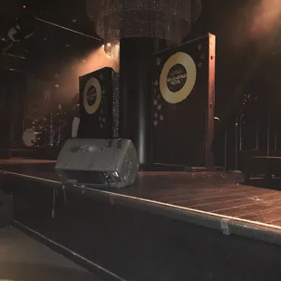 a stage with a piano, drum, and other instruments