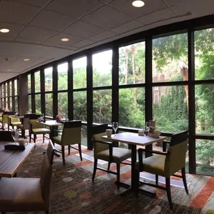 a dining area with tables and chairs