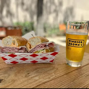 a sandwich and a glass of beer