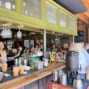 a group of people sitting at a bar