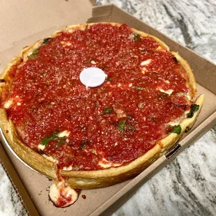 a deep dish pizza in a box