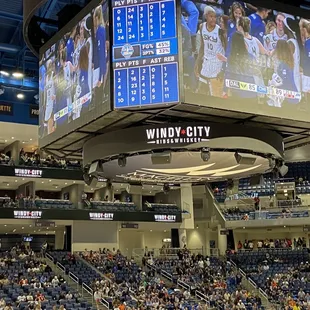 Sky scoreboard and jumbotron screens with Windy City sponsor ad.