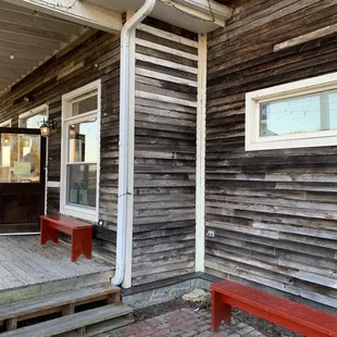 a red bench on the porch