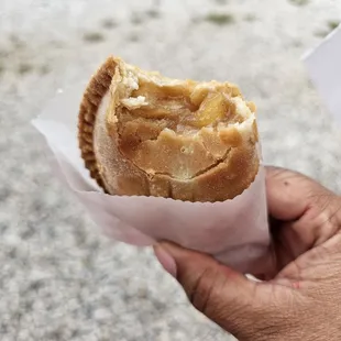 a hand holding a pastry