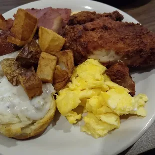 Fried chicken, bacon, country ham, scrambled eggs, cheese grits, potatoes and biscuits and sausage gravy.