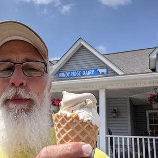 a man holding an ice cream cone