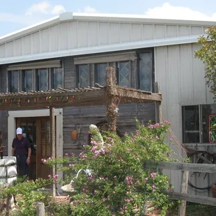 a man standing in the doorway of a winery