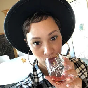 a woman drinking a glass of wine