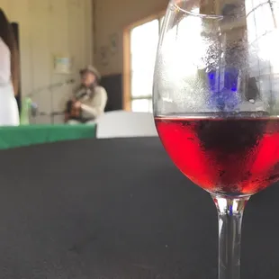 a glass of red wine on a table