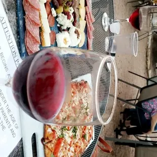 a plate of food and a glass of wine