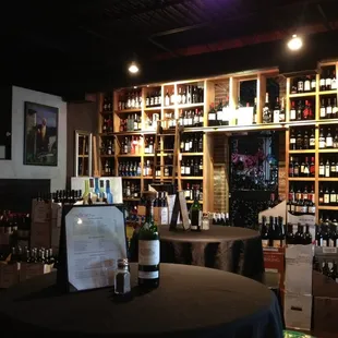 a wine bar with bottles of wine on the shelves