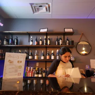 a woman behind a bar counter