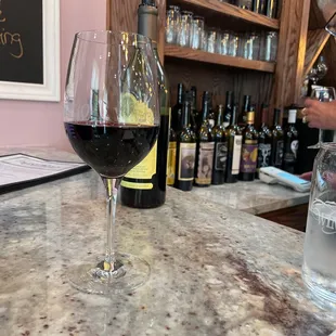 a glass of wine on a bar