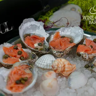 Crudo oysters on half she with smoked salmon and capers
