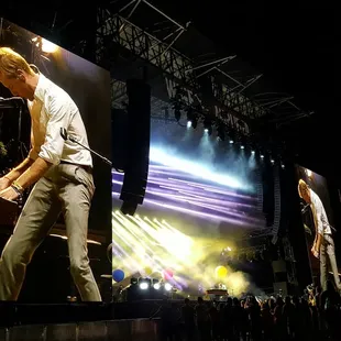 a man standing on a stage in front of a crowd