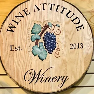 a wooden sign with grapes on it