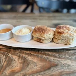 Side of biscuits with whipped butter topped with flaky salt and warm honey. Incredible.