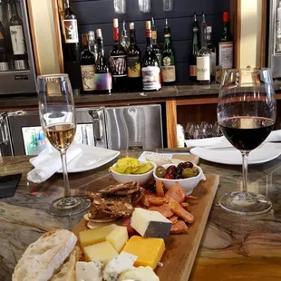 a wine glass and cheese board
