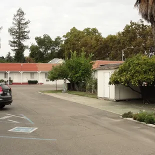 Picture of some of the rooms, and fruit trees next to the parking lot.