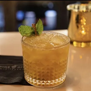 a drink in a glass with mint
