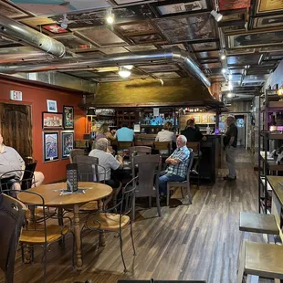 people sitting at tables in a restaurant