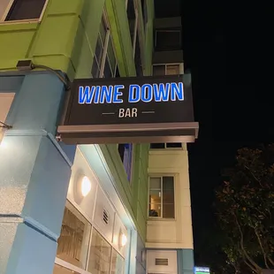 the outside of a wine down bar