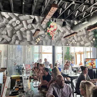 a large group of people sitting at a bar