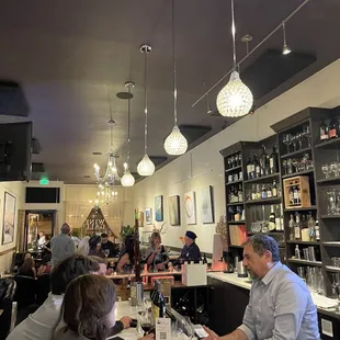 a group of people sitting at a bar