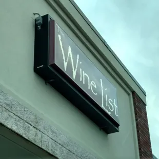 a wine list sign on a building