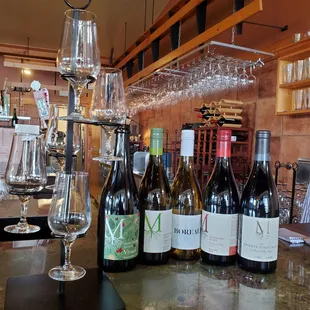 several bottles of wine on a bar