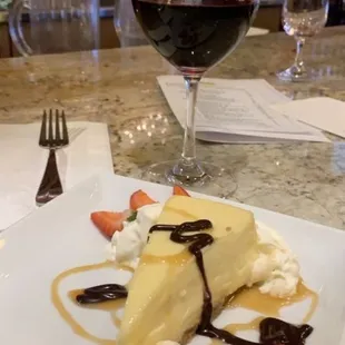 a piece of cheesecake with whipped cream and strawberries