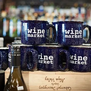 a stack of blue mugs