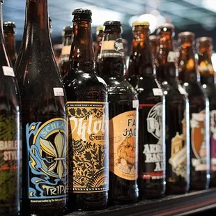 a row of beer bottles on a shelf