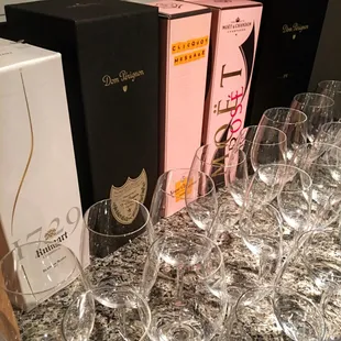 empty wine glasses lined up on a counter