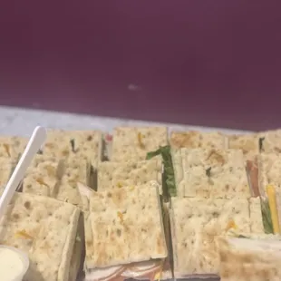 a platter of sandwiches on a table