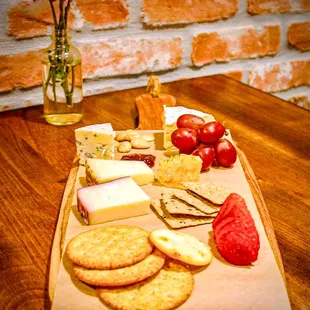 Cheese Board, Brie, Gorgonzola, Manchego, Artigiano Vino Rosso, honeycomb, fig jam, marcona almonds, crackers, grapes, strawberry.