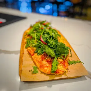 Flatbread pizza: Salami, multi colored peppers, artichoke hearts, tomatoes, cheese blend, oregano, topped w/ arugula. Delicious.