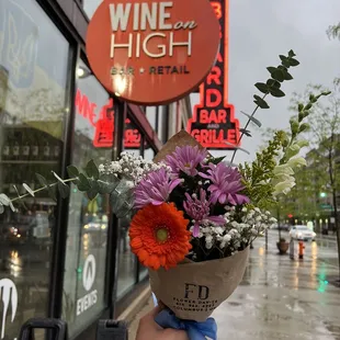 a person holding a bunch of flowers